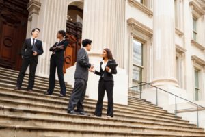People standing on the steps of a courthouse