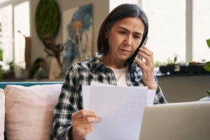 A person reviewing notes and making a phone call