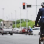 A bicycle rider stopped at a red light