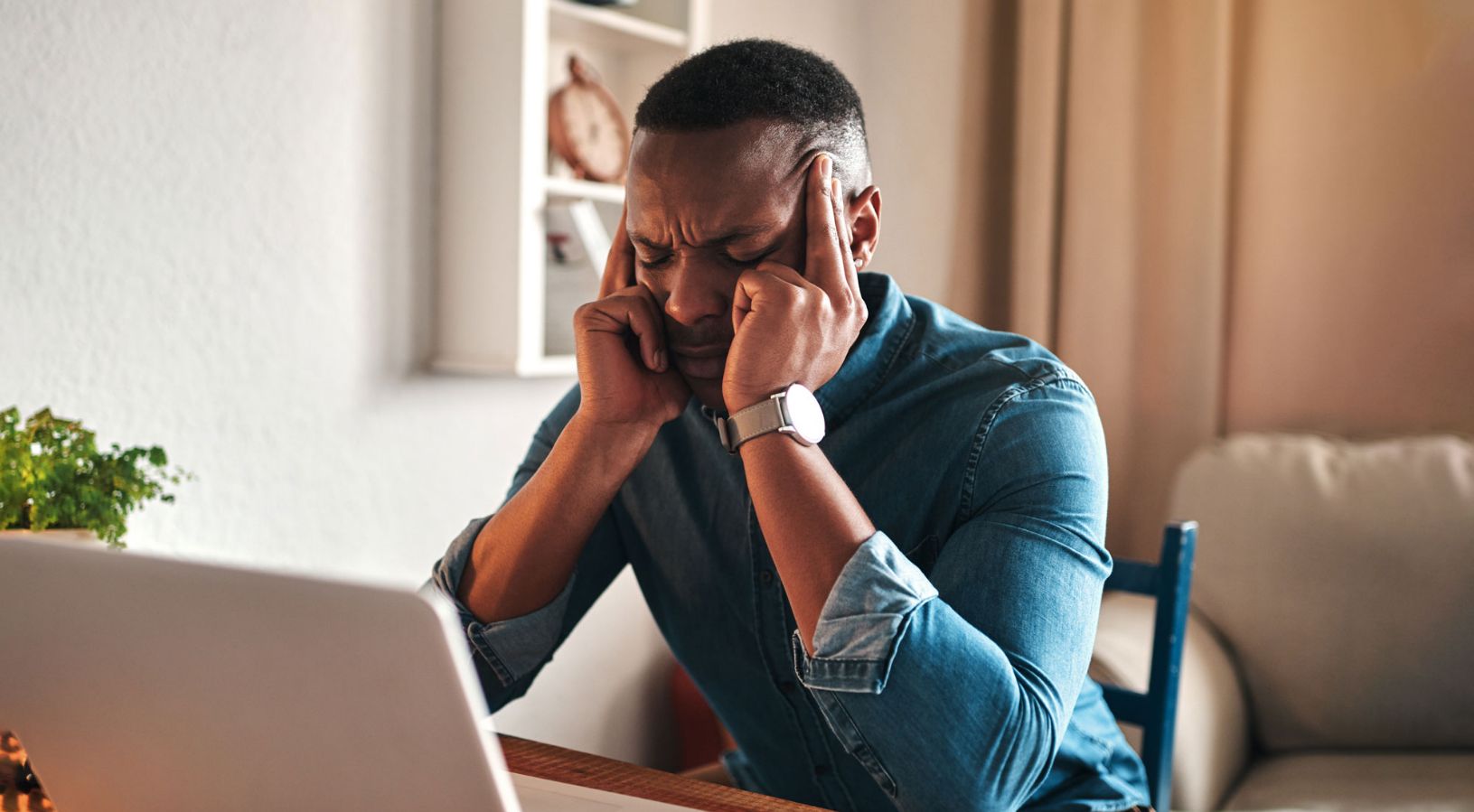 A man holding his head and in pain