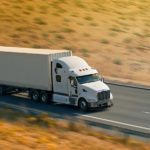 An 18-wheeler truck driving on the highway