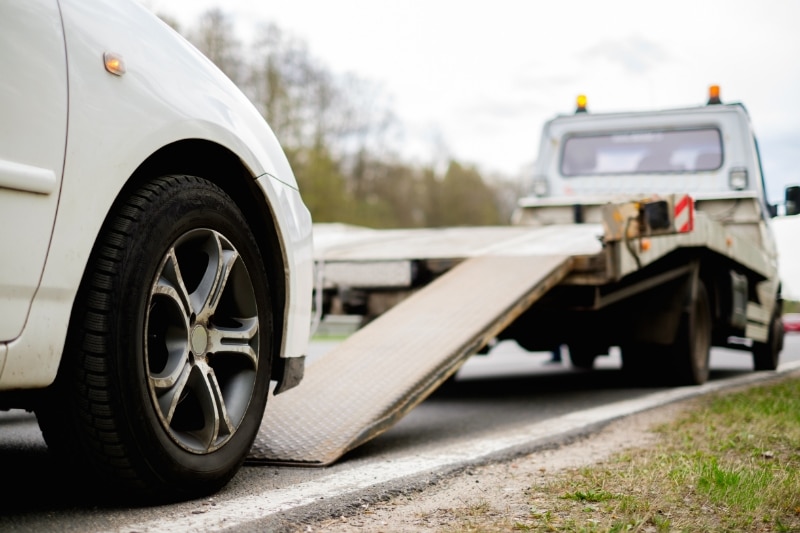 A car about to get put onto a tow truck after an accident